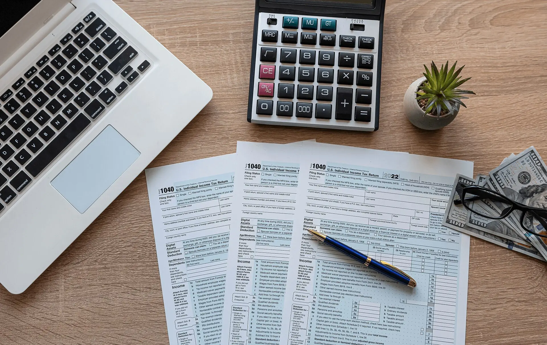 Tax forms with laptop and calculator